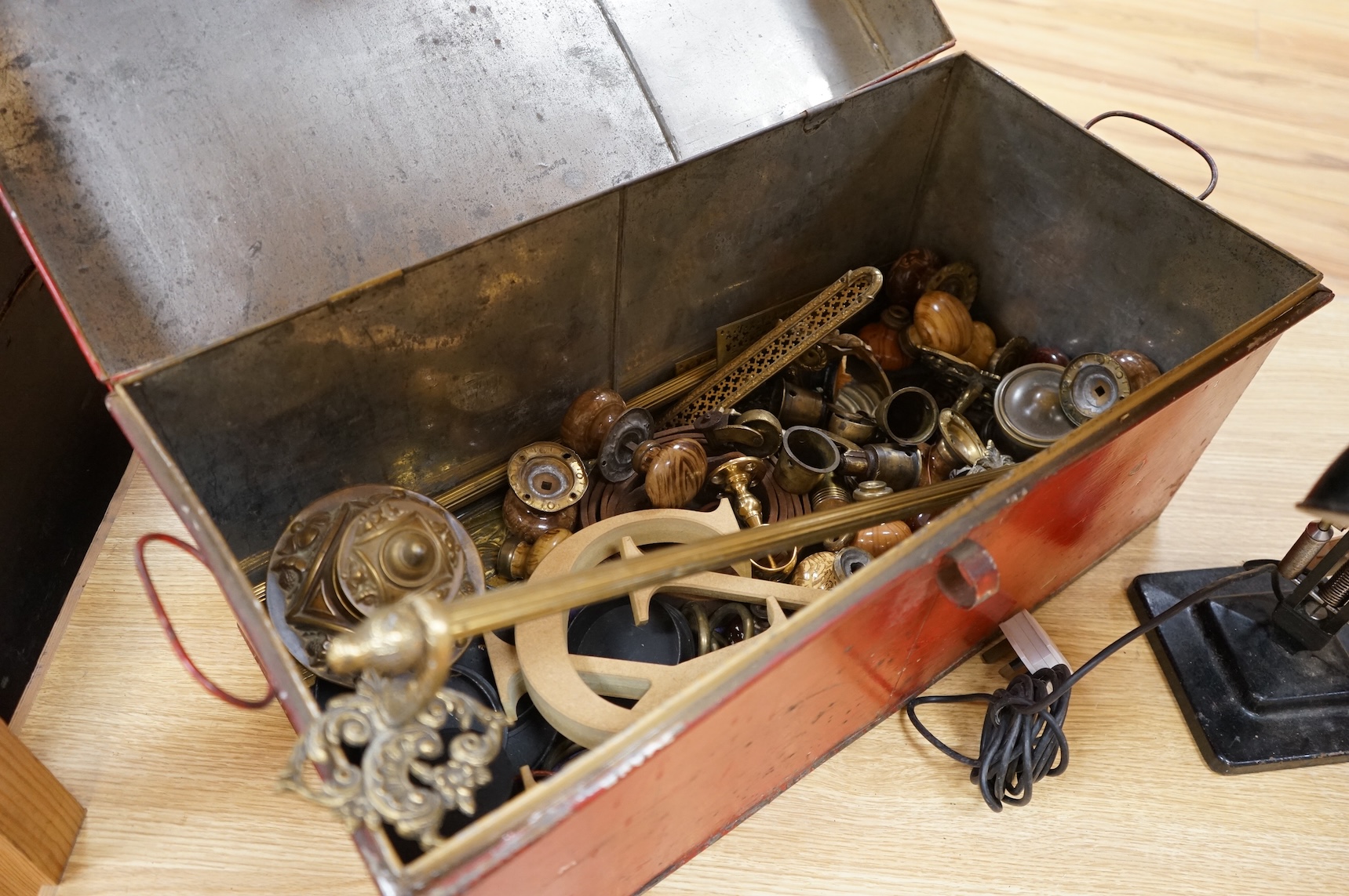 An Anglepoise lamp and metal door furniture and fittings in a tin trunk